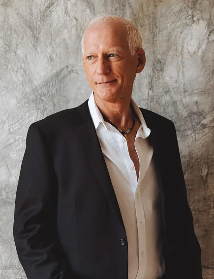 Portrait of Robbie McKenzie in a dark jacket and white shirt