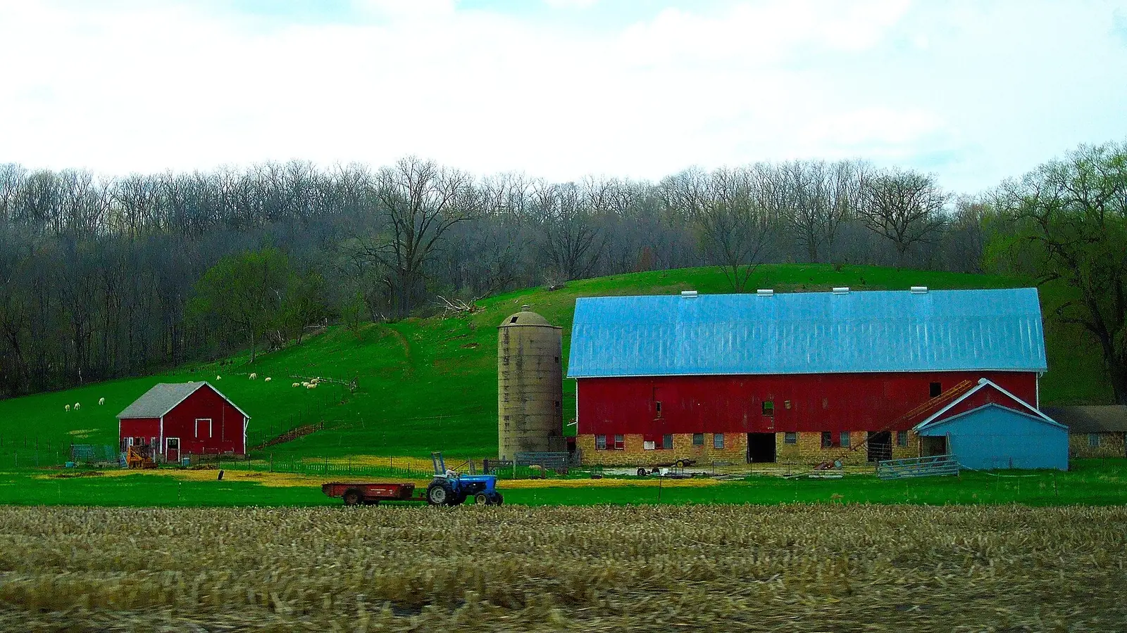 A long red barn and silo on a Wisconsin farm