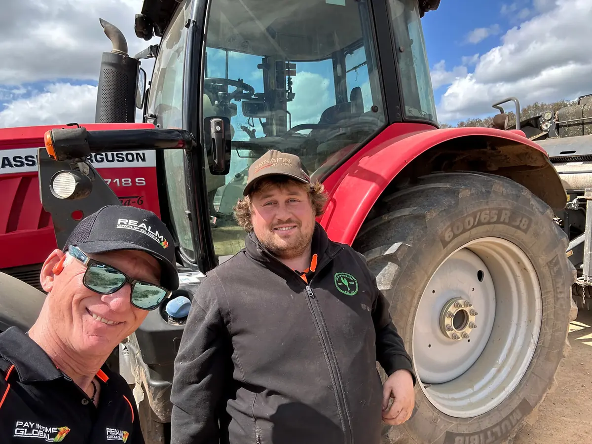 Two REALM team members standing in a field